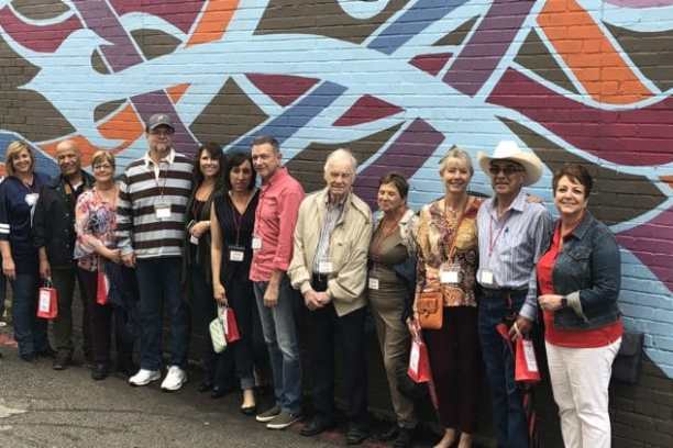 a group of people standing in front of a crowd posing for the camera