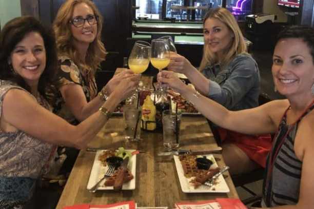 a group of people sitting at a table with wine glasses