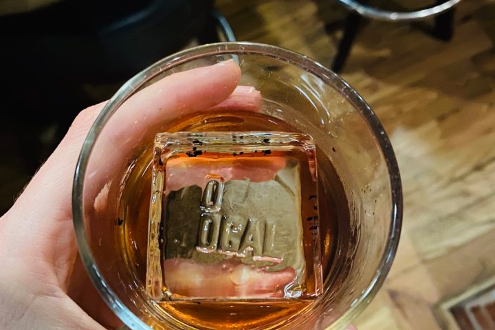 a hand holding a glass of wine