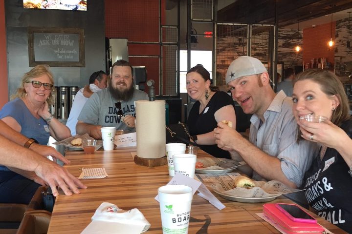 a group of people sitting at a table in a restaurant
