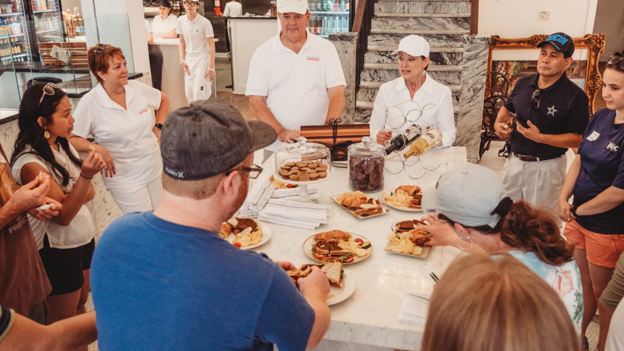 a group of people sitting at a table with food