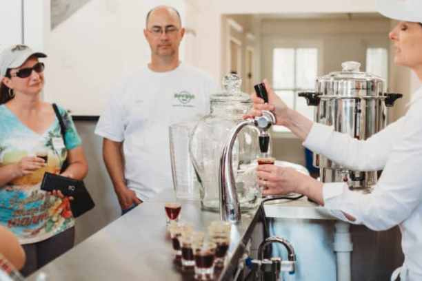 a group of people standing in a kitchen preparing food